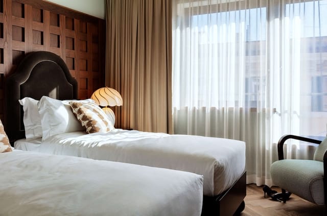 The Hoxton Rome twin corporate hotel room with modern design for business travel.