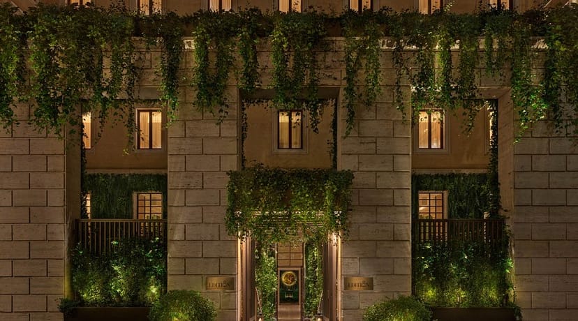 The Rome EDITION entrance: sophisticated green decor for executive retreats and evening receptions.