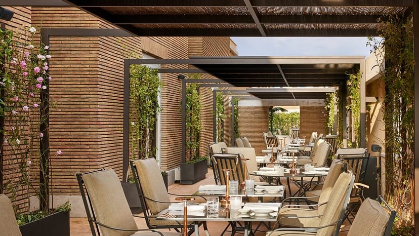 Upscale outdoor networking reception at Il Ristorante Niko Romito with elegant pergola.