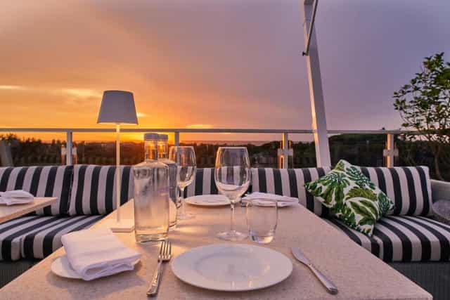 Rooftop sunset at Ristorante AcquaViva, Hotel Villa Pamphili for luxury networking and VIP dinners.
