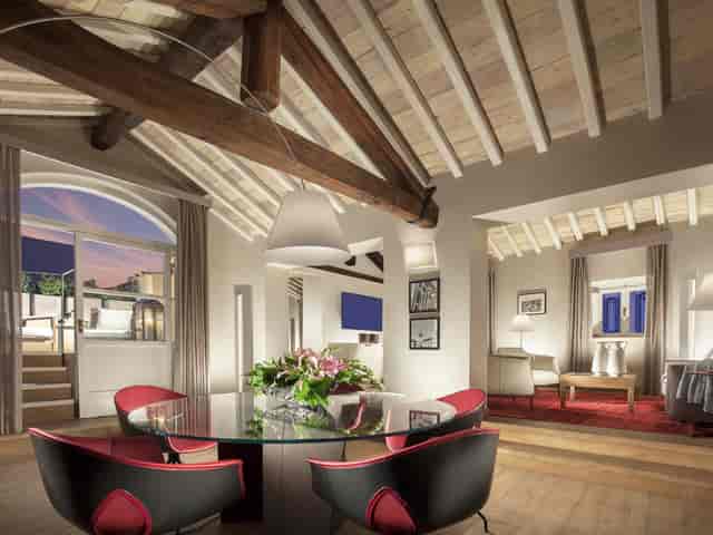 Ambassador Suite boardroom with rustic timber beams for VIP strategy sessions and private events.