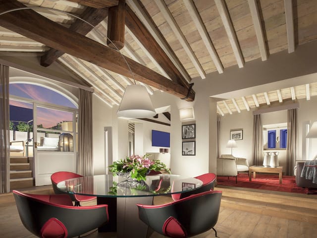 Ambassador Suite boardroom with rustic timber beams for VIP strategy sessions and private events.