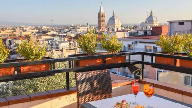 Sunset cocktail reception at Hotel Diana Roof Garden with iconic Roman cityscape view.