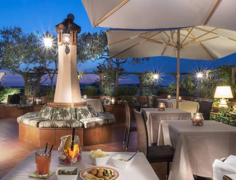 Rooftop terrace lounge at Hotel Diana for upscale networking events and VIP dinners.