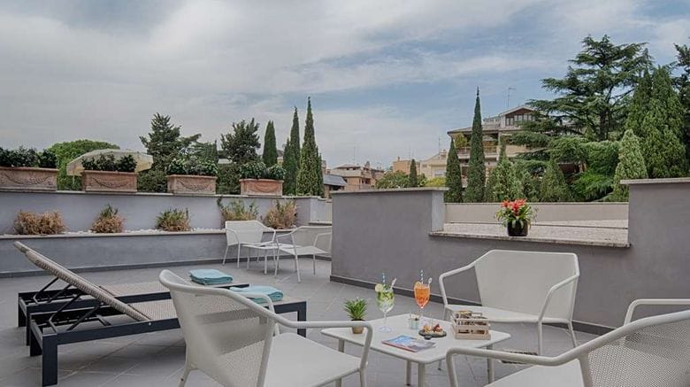 Modern terrace for networking events at NH Roma Villa Carpegna, featuring sleek modular seating.
