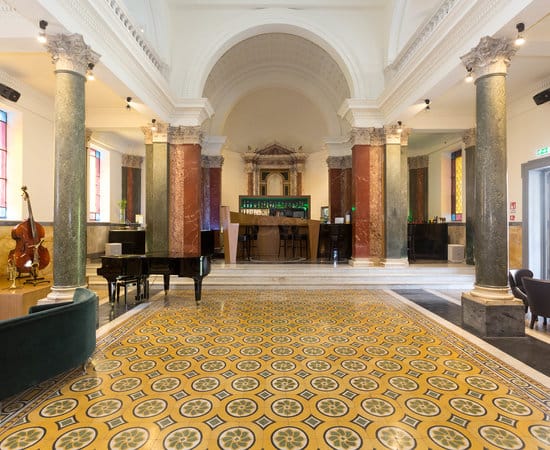 Grand hotel lobby with permanent bar, ideal for cocktail receptions and networking events.