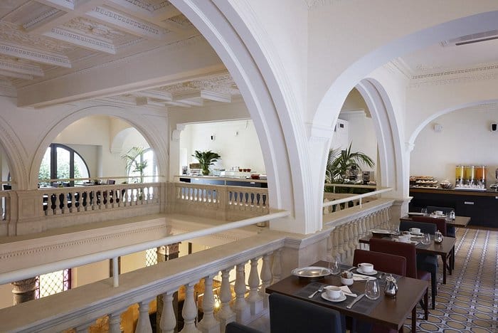 Elegant lounge bar at The Building Hotel with architectural arches for networking and cocktails.