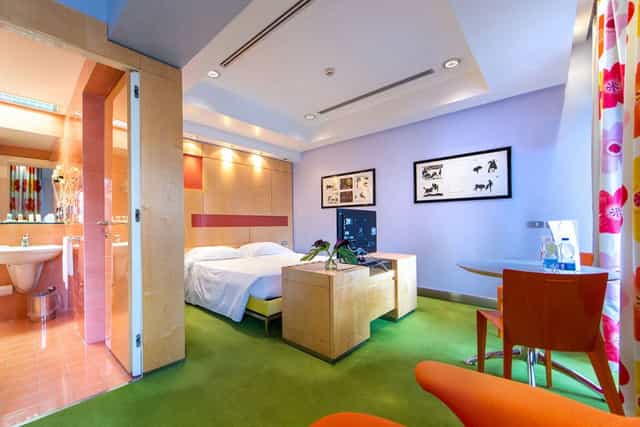 Modern hotel suite with workspace for business travel and solo accommodation.