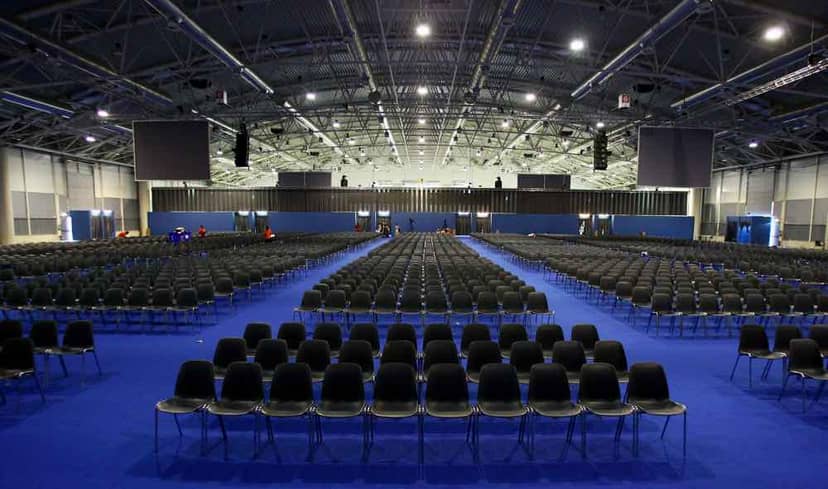 Theater-style plenary session setup at Fiera di Roma exhibition hall for corporate conference events.
