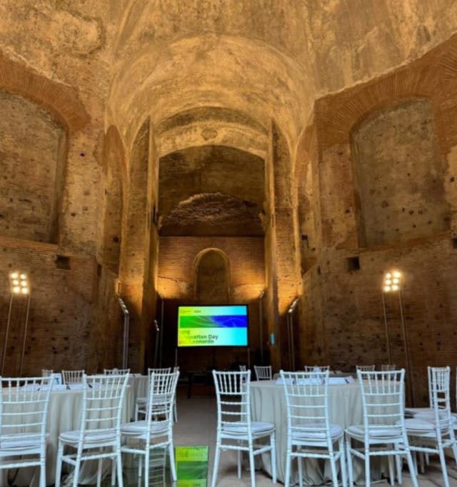 Historic Great Hall ruins venue with stage setup for corporate event or luxury gala.