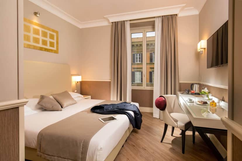 Modern hotel room with executive workspace for corporate retreats and business travel.