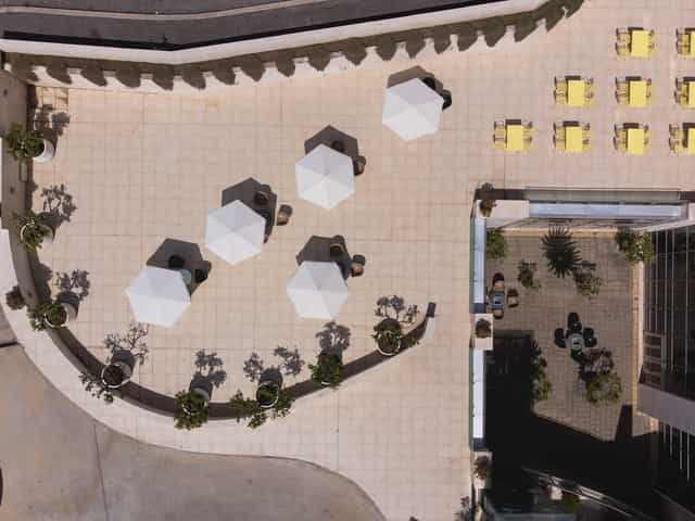 Rooftop auditorium venue with lounge seating for corporate breakout sessions and networking events.