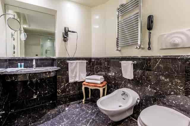 Luxury marble bathroom in Trilussa Palace Hotel Belli Room for upscale VIP hospitality suites.