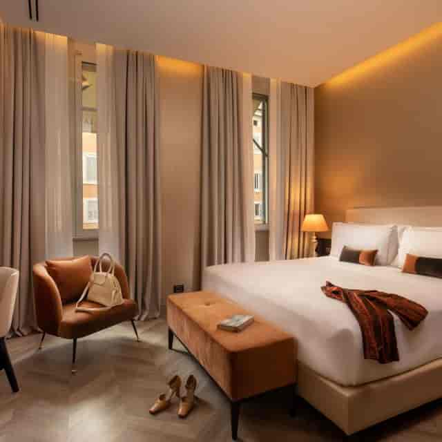 Luxury hotel room for VIP conference speakers, neutral-toned executive accommodation.