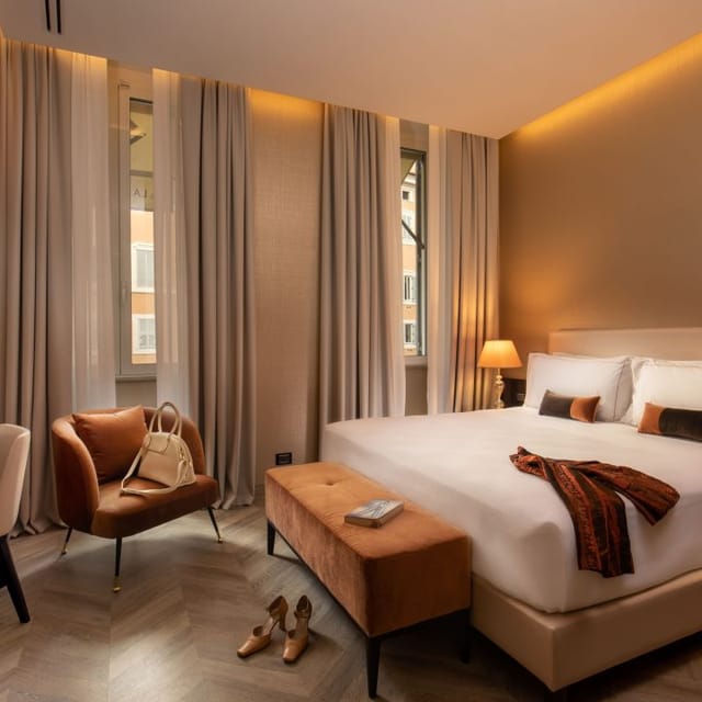 Luxury hotel room for VIP conference speakers, neutral-toned executive accommodation.