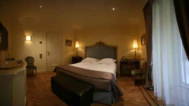 Executive hotel suite with hardwood floors for corporate travel and business accommodation.