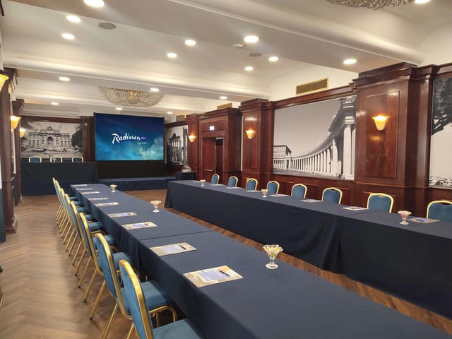 U-shaped boardroom at Radisson Blu Rome with wood accents, ideal for professional meetings & events.