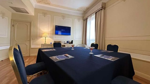 Boardroom meeting space at Radisson Blu Rome with square table layout for corporate events.