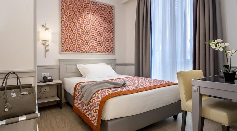 Hotel Della Conciliazione suite with workspace for corporate travel and hotel room blocks.