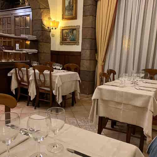 Rooftop restaurant at Suite Ludovisi with rustic dining tables for cozy event venue hire.