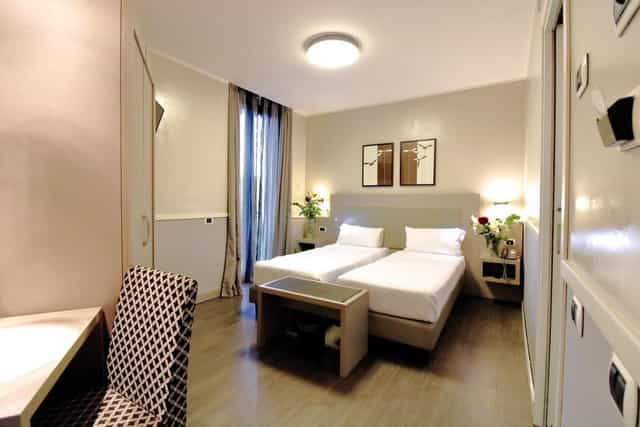Twin-occupancy hotel room at Noba Hotel & Residenze for conference accommodation.