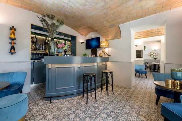 Blue bar in Rome lounge with vaulted brick ceilings for VIP events and networking receptions.