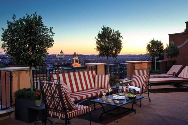 VIP welcome reception at La Ville Rome bar with skyline view and lounge seating.