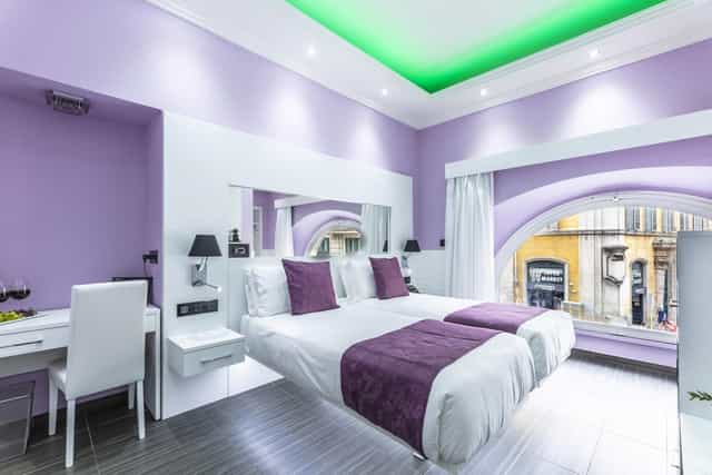 Deluxe twin room at THE ONE Boutique Hotel with ergonomic workspace for incentive travel events.