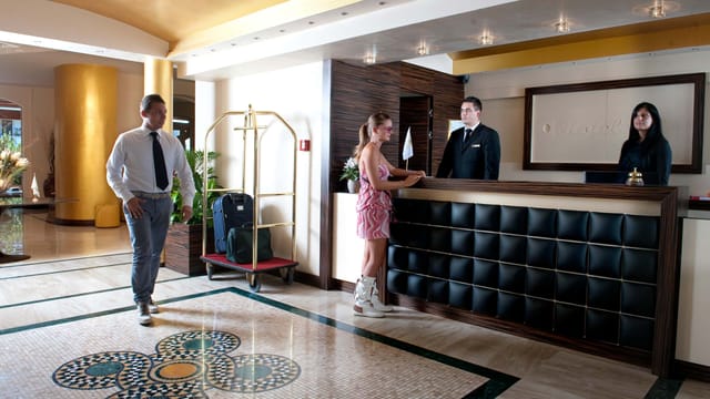 O.C. Hotel Roma front desk for group check-ins and corporate event planning.