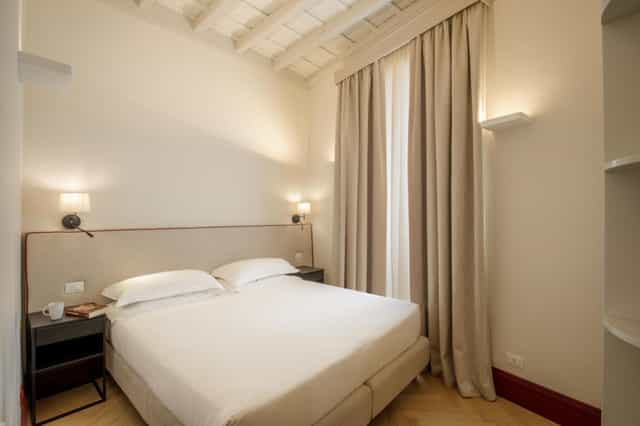 Boutique hotel room for VIP accommodations, neutral decor, ideal for conference event lodging.