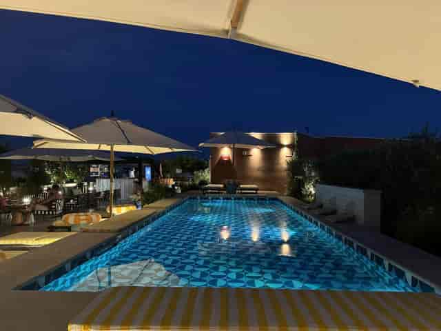 Upscale rooftop cocktail reception at W Rome featuring pool and ambient lounge lighting.