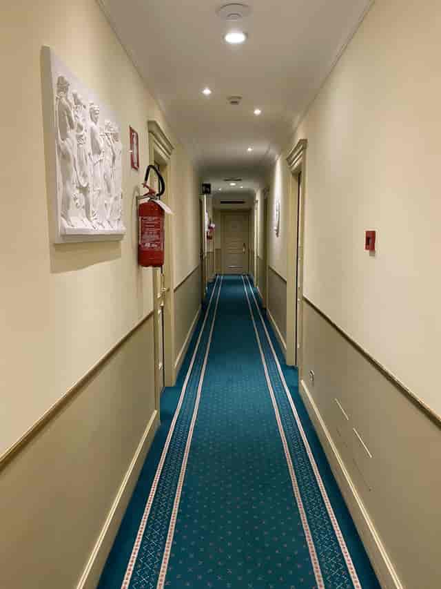 Donna Laura Palace hotel meeting room corridor with fire safety equipment, event venue site visit.