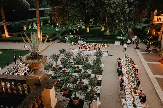 Elegant outdoor gala dining setup at Villa Aurelia with ambient landscape lighting.