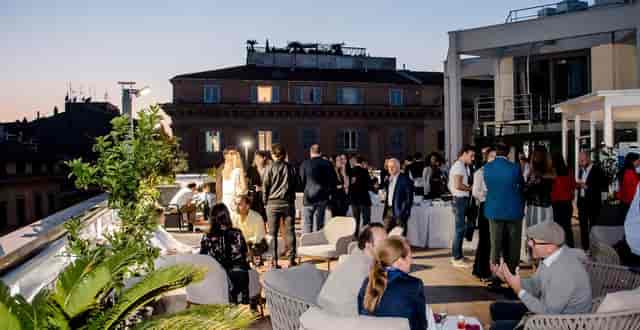 High-end rooftop networking reception at The Hive with urban skyline backdrop.