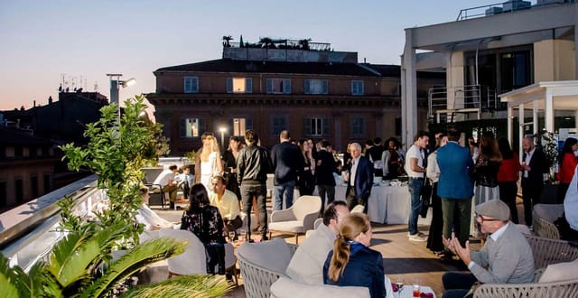 High-end rooftop networking reception at The Hive with urban skyline backdrop.