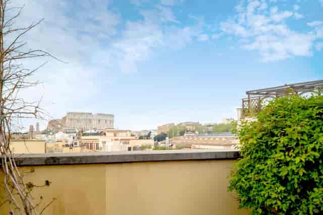 Rooftop terrace with Colosseum view for corporate events and luxury cocktail receptions in Rome.
