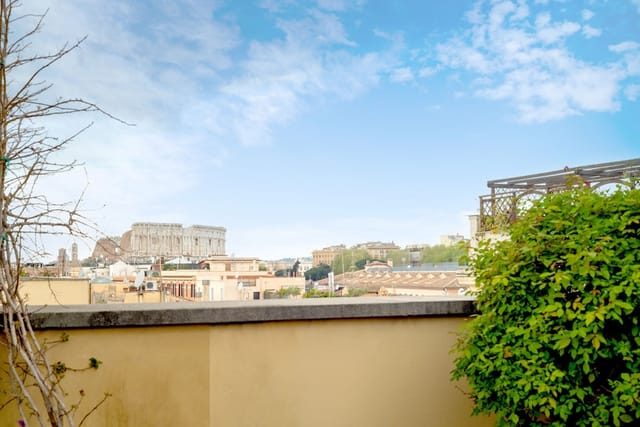Rooftop terrace with Colosseum view for corporate events and luxury cocktail receptions in Rome.