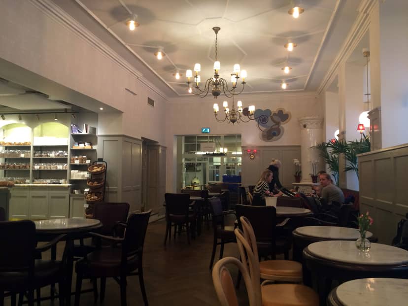 Sophisticated high-ceilinged cafe venue for networking and corporate breakout sessions.