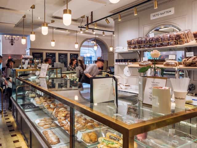 Elegant Vetekatten cafe interior for corporate breakfast briefings and networking events.