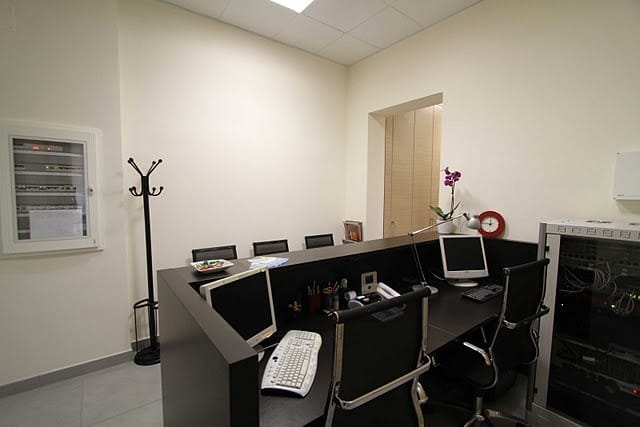Functional production office at Alma Business Center for event registration and onsite operations.