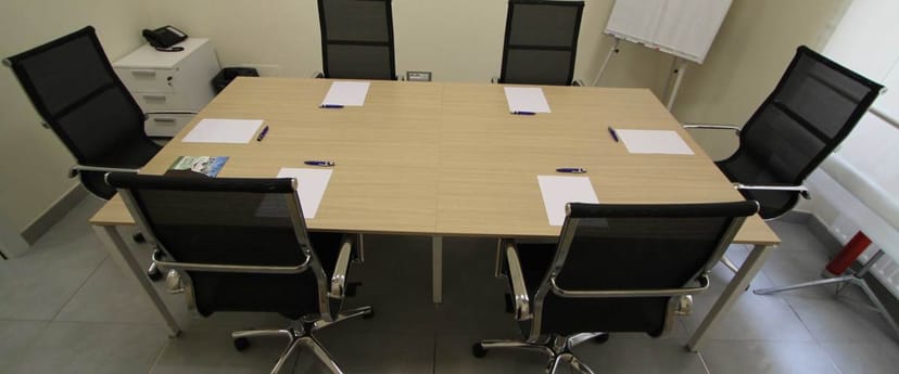 Boardroom setup for four at Sala G. Cesare, Alma Business Center, ideal for corporate meetings.
