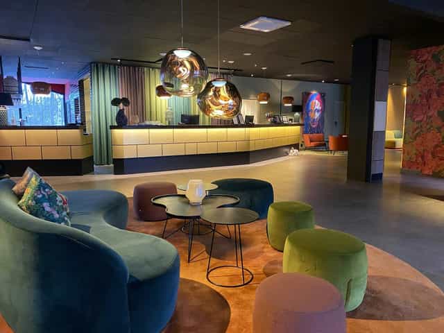 Contemporary hotel lobby with lounge seating for networking and conference registration.