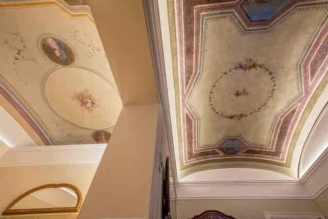 Historic meeting room at Hotel Canada with ornate frescoed ceilings for gala or board events.