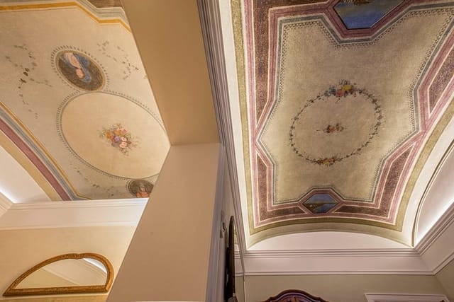 Historic meeting room at Hotel Canada with ornate frescoed ceilings for gala or board events.