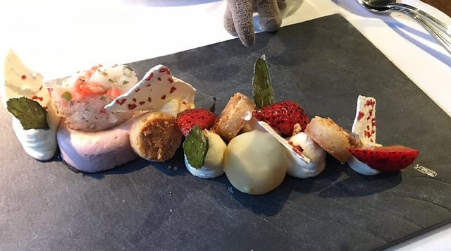 Artfully plated dessert on slate board for high-end gala catering event.