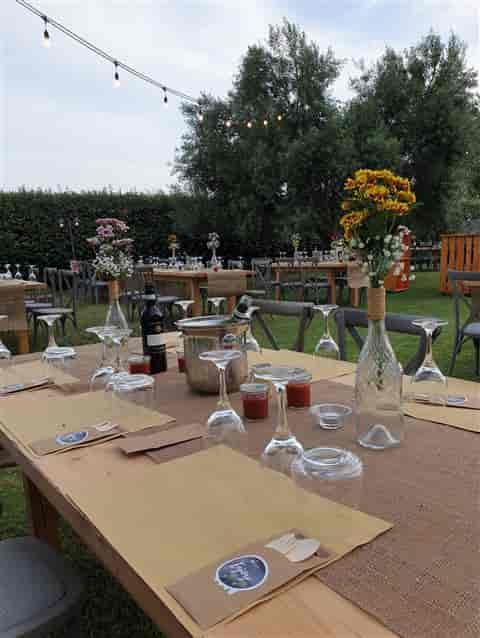 Rustic-chic garden event setup with wooden chairs at Rome Marriott Park Hotel for weddings or galas.