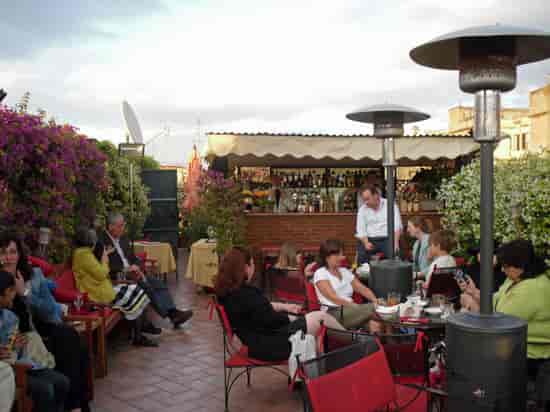 Rooftop terrace networking reception at Hotel Forum with heated outdoor bar area.