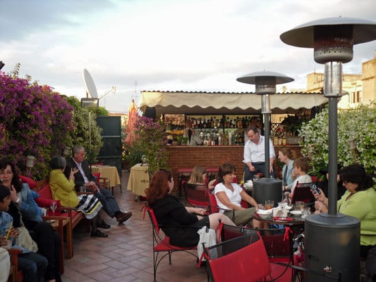 Rooftop terrace networking reception at Hotel Forum with heated outdoor bar area.