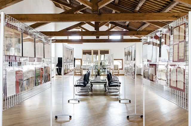 Rustic-chic Salone degli Affreschi venue with mesh walls for corporate exhibition and workshop.