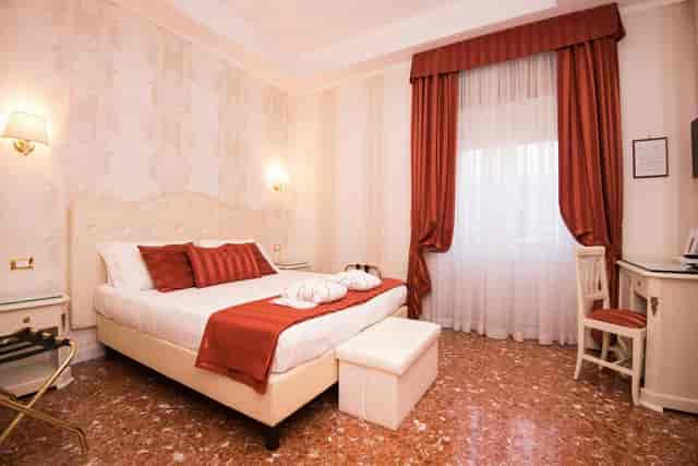 Classic hotel room with workspace at Navona Queen Rome for business travel and conference lodging.